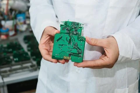 Technician with computer circuit board with chips. Spare parts and components Stock Photos