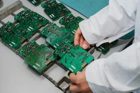 Technician with computer circuit board with chips. Spare parts and components Stock Photos