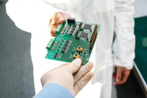 Technician with computer circuit board with chips. Spare parts and components Stock Photos