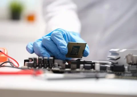 Technician connects a CPU microprocessor to motherboard socket 写真素材