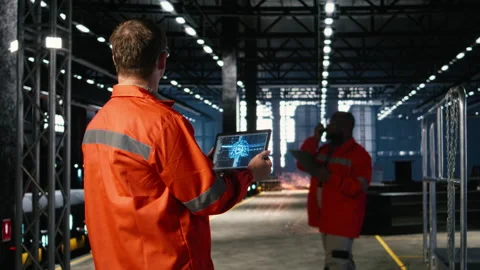 Technician controls automation machinery guided by AI and machine learning Stock Footage 321916425