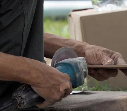 Technician cut tile with cutting machine  without protect item for hand Stock Photos