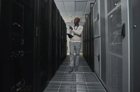 Technician, cybersecurity and man in the server room for data maintenance, it or Stock Photos