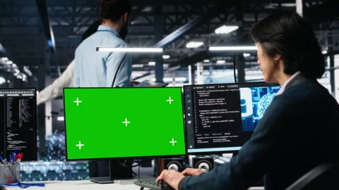 Technician in data center coding with generative AI on green screen PC Stock Footage 313636598
