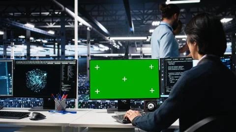 Technician in data center coding with generative AI on green screen PC Stock Photos