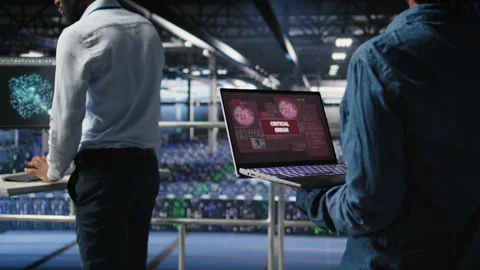 Technician in data center stressed by critical error popup on laptop Stock Footage 310278068