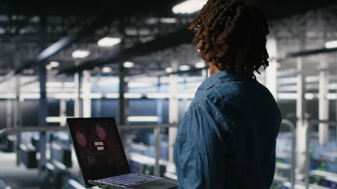 Technician in data center stressed by critical error popup on laptop Stock Footage 310785097