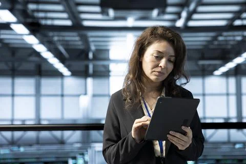 Technician in data center using tablet, conducting security audits Stock Photos