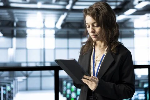 Technician in data center using tablet, integrating green technologies Stock Photos