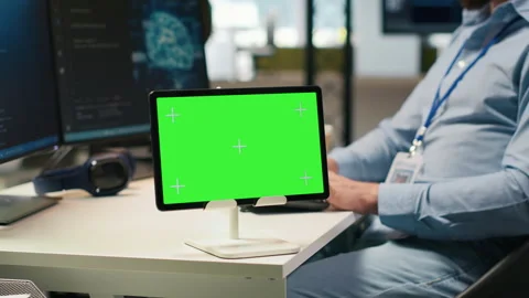 Technician developing applications using chroma key tablet, integrating AI Stock Footage 313164432