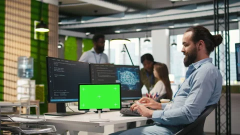Technician developing applications using chroma key tablet, integrating AI Stock Footage 313165444