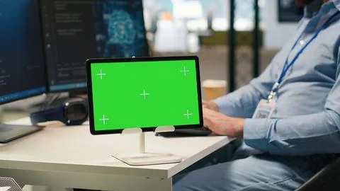 Technician developing applications using chroma key tablet, integrating AI Stock Photos