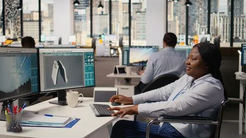Technician with disability creating solar powered device design Stock Photos