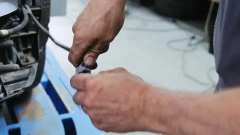Technician disconnects wire working on electrical system Stock Footage 317634029