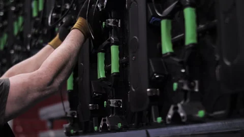 Technician dismantling modular LED video wall Stock Footage 307755926