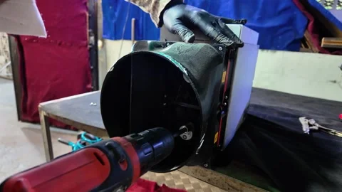 Technician drilling into electronic device housing during repair process Stock Footage 323284641