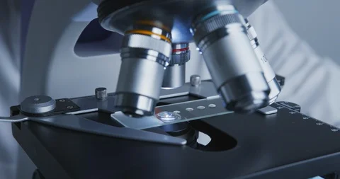 Technician drips a solution from pipette on the glass slide for further Vídeo Stock 120729285
