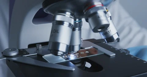 Technician drips a solution from pipette on the glass slide for further Stock-Footage 120729595
