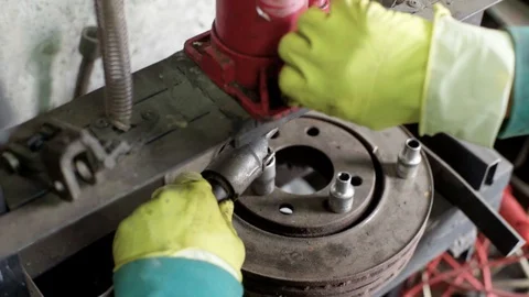 Technician during process of universal joint repair using hydraulic press Stock Footage 128921369