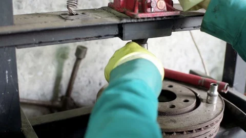 Technician during process of universal joint repair using hydraulic press Stock Footage 128921434