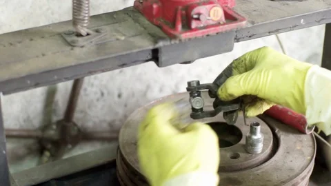 Technician during process of universal joint repair using hydraulic press Stock Footage 128921505