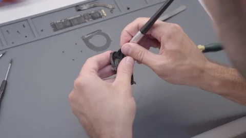 The technician engineer cleans a computer fan from dust with a soft brush Stock Footage 91335156