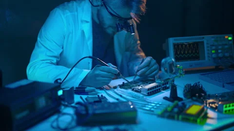 Technician engineer developer is soldering iron pcb microcircuit electronic Stock Footage 237821840