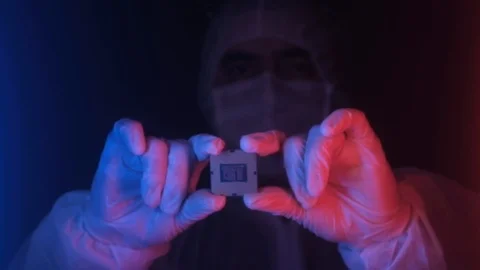 Technician engineer in lab holds a computer processor in neon light 库存影片 121301362