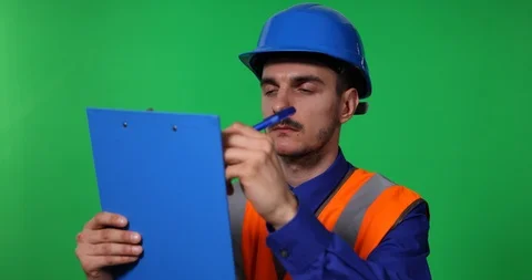 Technician Engineer Man Writing on Clipboard Looking Up Green Screen Background Stock Footage 87951637