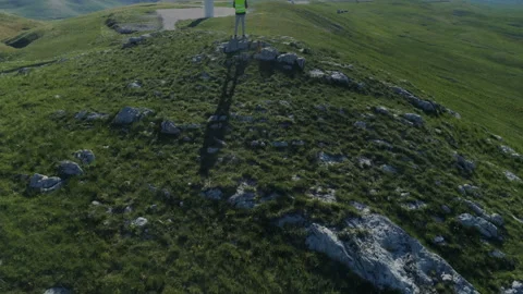 Technician Engineer in Wind Turbine Power Generator Station launches a drone for Stock Footage 131392680