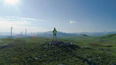 Technician Engineer in Wind Turbine Power Generator Station launches a drone for Stock Footage 131392998