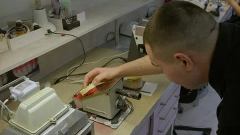 Technician evaluating the production quality of the denture base replacement Stock Footage 248557053