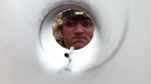 Technician examines pipe interior before repair work Stock Footage 337160745