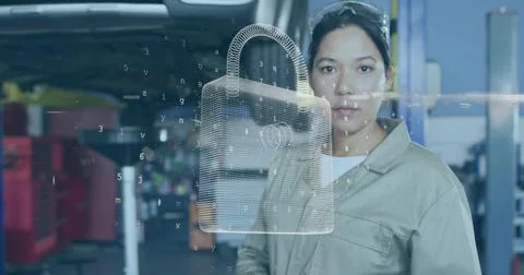 Technician examining 3D padlock interface in workshop, wearing coveralls and  Stock Photos