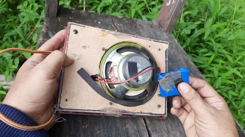 Technician Examining Broken Red Portable Speaker Outdoors Stock Footage 310263595