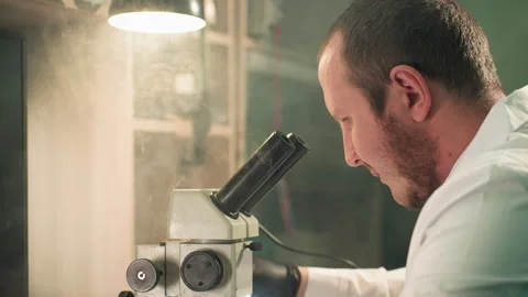 Technician Examining Circuit Board Under Microscope in Detailed Lab Environment Video stock 284359706