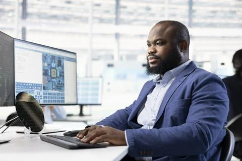 Technician examining microchip circuit design on PC display Stock Photos