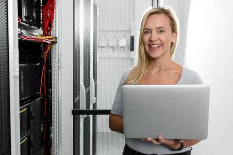  Technician examining server in server room with laptop Portrait of techni... Stock-Fotos
