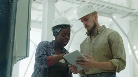 Technician Explaining Work of Electrical Panel to Colleague Stock Footage 209154392