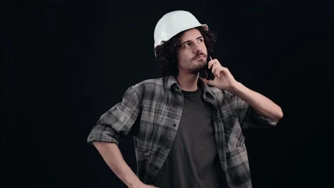 The technician explains by gesturing to the phone call and listens carefully to Stock Footage 156278319