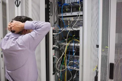 Technician feeling frustrated over servers Stock Photos