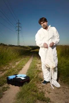 Technician in fields dressing DNA free protective equipment Stock Photos