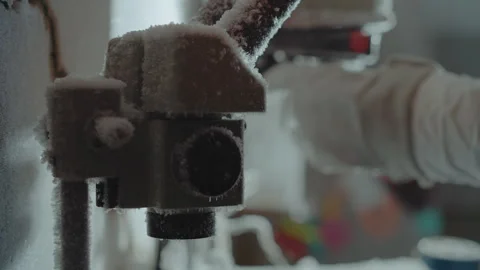 Technician finetunes icy microscope. Restoration specialist calibrates foggy Stock Footage 346471113