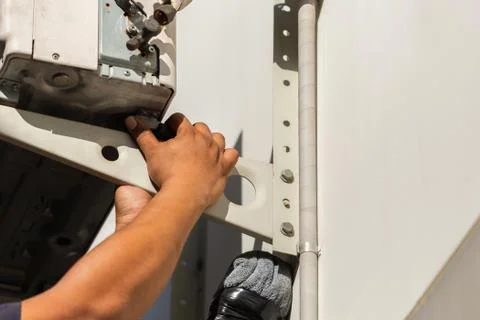 Technician fixing air conditioning system, man hand uninstall air conditioner 스톡 사진