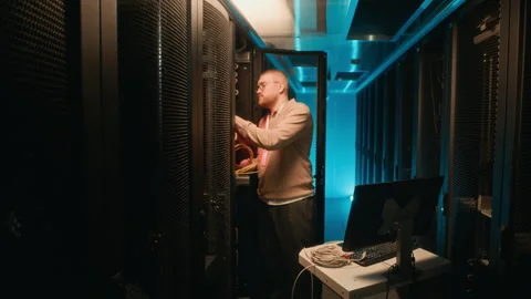 Technician Fixing Cables in Supercomputer in Data Room Stock Footage 311307248