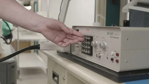 Technician flipping toggle switches to test electrical equipment in a Stock Footage 139639378