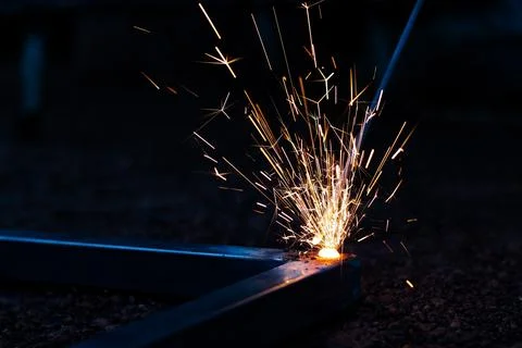 Technician focus on welding process on spark light with equipment. Stock Photos