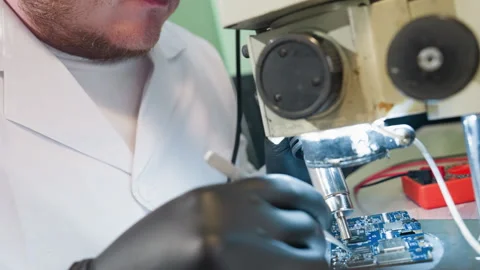 Technician Focusing on Circuit Board Under Microscope in Laboratory Stock Footage 282302273