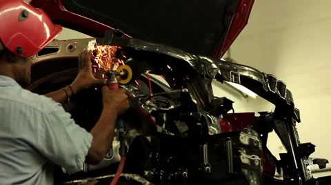 Technician grinding on vehicle upper frame rail Stock Footage 25879005