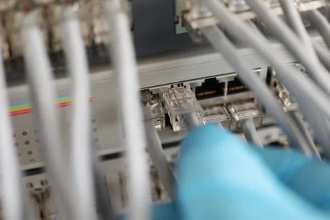 Technician hand connect switch ethernet cables and port to internet switch Stock Photos